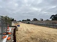 Sandy construction site next to railway tracks