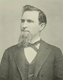 Upper-body portrait of a man in a suit.