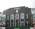 The Time Building on Station Road with a Miller-branded clock - formerly home of Time nightclub in 2000; today part converted into residential use