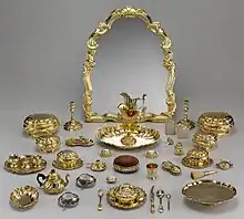 The set is mostly in silver-gilt, but includes two Japanese Imari ware teacups