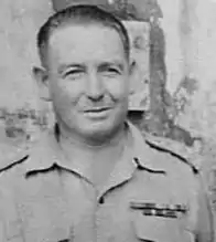 A black and white head and shoulders photograph of a middle-aged man in uniform