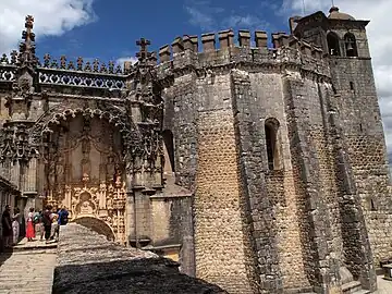 The 12th-century Romanesque Charola (round-church) on the right compared with the 16th-century Manueline church on the left.