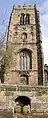 Tower from the west showing the water trough built into the wall, the clock and the louvred bell tower