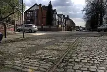 Tramlines running along a cobbled road in Broughton.