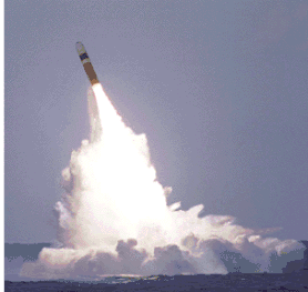 Blunt-nosed missile, with its rocket motors fired, splashes huge white waves as it positions itself on an angle for a ballistic firing.