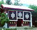 Tsozong Gongba Monastery auxiliary building with 3 'endless knots' above the door.