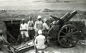 Although short ranged the 10.5 cm Feldhaubitze 98/09 was capable of high angle indirect fire.  Guns like this became more common during WWI as both sides dug in.  Most guns produced after WWI were capable of high angle fire and had longer range.