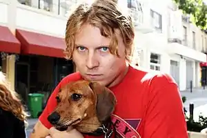 Ty Segall posing with his dog, Fanny, in 2016