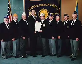 Members of the Ukrainian American Veterans meet with New Jersey Commissioner of Veteran Affiars Michael Warner after the presentation ceremony for Ukrainian Independence Day. From left: Alex Zanko, Michael Wengryn, John Tymash, Commissioner Mike Warner, Commander George A. Miziuk, Robert Iwanczewsky, John Pawlow, Bernard Krawczuk and John Zakanycz. Photo Credit: Roman M. Martyniuk