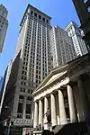 Federal Hall, once the U.S. Custom House, now a museum, with the towers of Wall Street behind it