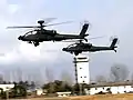 AH-64D Apache Longbow helicopters flying at Camp Humphreys in February 2004.