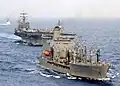 John Lenthall, right foreground, prepares to refuel the aircraft carrier USS Harry S. Truman, aft left, in the Mediterranean Sea.