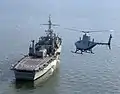 A RQ-8A Fire Scout helicopter preparing to land on USS Nashville