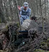 A Special Forces Master Sergeant gives pointers to two other Special Forces soldiers at a NATO sniper course in Germany.