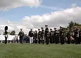 The United States Navy Ceremonial Band, under the direction of the Drum Major, Master Chief Musician Joe D. Brown Jr., standing at attention as Marine General Peter Pace approaches their formation during the change of command ceremony for the Chairman of the Joint Chiefs of Staff.