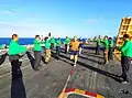 Capt. Rory Macdonald, Canadian Forces chaplain, runs aboard a nuclear-powered aircraft carrier.