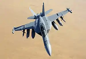 US Navy An E-A-18G Growler from Electronic Attack Squadron (VAQ) 129 N40562-21 carrying similar equipment.  The spinning blades on the ram air turbines appear blurred.