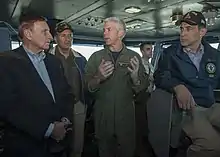 Capt. Karl Thomas, commanding officer of the Nimitz-class aircraft carrier USS Carl Vinson, speaks on 22 October 2014 with U.S. Representatives John Mica, left, from Florida, Juan Vargas, middle, and Darrell Issa, seated, from California, on the navigation bridge. Carl Vinson and its embarked air wing, Carrier Air Wing 17, are deployed in the U.S. 5th Fleet area of operations supporting Operation Inherent Resolve, strike operations in Iraq and Syria as directed, maritime security operations, and theater security cooperation efforts in the region.