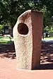 Granite sculpture consisting of a rough-hewn rectangular pillar enclosing a more polished rectangular internal structure