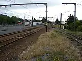 Looking south from Upper Hutt station platform. The dock is to the right, the main line to the left of the platform, and the crossing loop at far left. To the left of the crossing loop is the southern entrance to the EMU storage area.