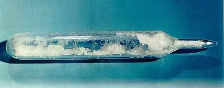 Snow-like substance in a sealed glass ampoule.