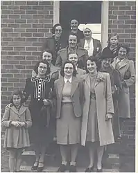 Some of Tallangatta VAOC members pose at the steps of the observation post - circa 1944. Front row from left: Olga Smith, Mrs A. Smith, Maise Tait, Thelma Butler. Second Row - Mrs Ballantyne, Helen Tait, Mrs J. L. Fisher. Third row: Madge Maddock, Mrs H. G. Heath and daughter behind. Fourth row: Miss Myrtle Ruby, unknown, Mrs Pearl Foster.  Photo: Thelma Moyle.