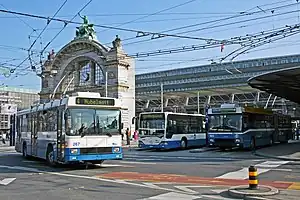 Buses in front of large archway