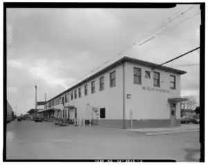 A black and white photo of a two-story stucco-covered railroad station