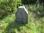 About 500 m north-east of the farmhouse and not far from the shore of the la goon there stands in the grassy veld about 35 steps from a row of gumtrees, a beacon of blue-black Malmesbury shale with the inscription G \VOC (Geoktrooieerde Verenigde Oos-Indi This black slate stone beacon with the inscription G VOC chiselled thereon was presumably erected in 1785 by Governor Cornelis Jacobus van der Graaff to indicate the western boundary of the Cape District.
The farm Geelbek, earlier called Geelbekefontein,
Type of site: Beacon