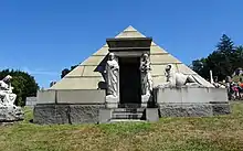 A pyramid, about 3 m tall, with statues