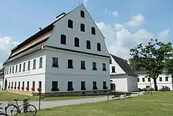 A complex of paper mill buildings with white facades