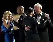 Joe and Jill Biden dancing with members of the U.S. armed forces at the Commander in Chief's Ball. Silk blue gown by Vera Wang.