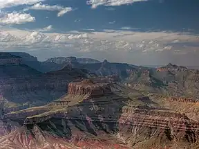 view opposite Lipan Point, (at Desert View (Grand Canyon), East Rim), showing the banded Nankoweap Formation, (horizontal Tapeats at left, extending at base of prominence, in two fingers of rock)