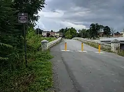 A view of Van Metre Ford Bridge from what was originally Golf Course road, but is now a defunct road that is used for parking.