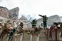 Rescuers are sorting through the rubble of the partially destroyed concert hall ‘Officers' house’