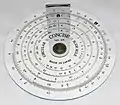 A simple circular slide rule, made by Concise Co., Ltd., Tokyo, Japan, with only inverse, square, and cubic scales. On the reverse is a handy list of 38 metric/imperial conversion factors.