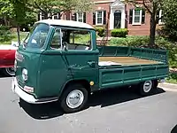 Volkswagen Type 2 with single cab over and a drop side bed with the left panel folded down