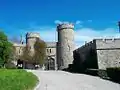 Entrance to the palace forecourt in the style of a medieval English castle.