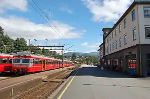 Two commuter trains parked at a mid-sized station