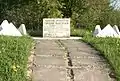 A memorial stone of the Vyshgorodok hill fort that reads "An archeological monument – Vyshgorodok hill fort. Founded in 1476. During the 15th–16th centuries it was one of the fortifications on the westernmost frontier of the Pskovian Land. Preserved by the Government."