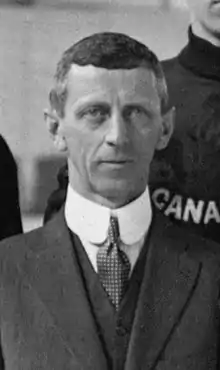 Black and white photo of a middle-aged man in a suit and tie