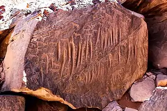 Boulder with engraved animals