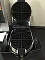 This is a waffle iron of the type commonly found at breakfast counters at motels/hotels in America. Customers pour in batter, close the waffle iron, and a timer begins, then sounds off when the waffle is ready.