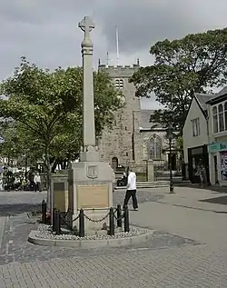 Stone column with a cross at the top.