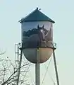 The water tower consists of a cone, a cylinder, and a hemisphere. Its volume can be calculated using solid geometry.