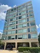 The west face of Waterfront Tower, featuring large glass windows and concrete columns.