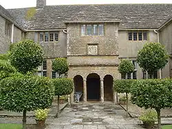 Two storey house with columns in front of the door