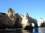 Cliffs of a coastline in Portugal that have denuded due to erosion and weathering primarily from water and salt.