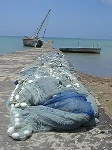 A wharf at Mkoani during the daytime with fishing nets being dried in the sun