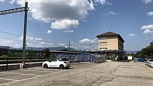 Four-story building with hip roof and canopy-covered platforms